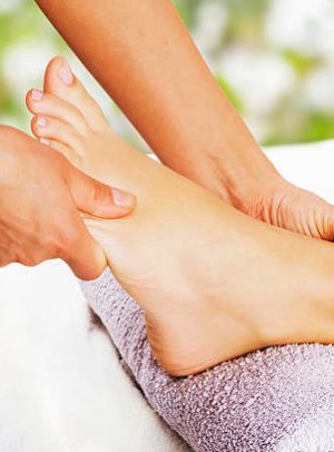 Foot massage in the spa salon in the garden